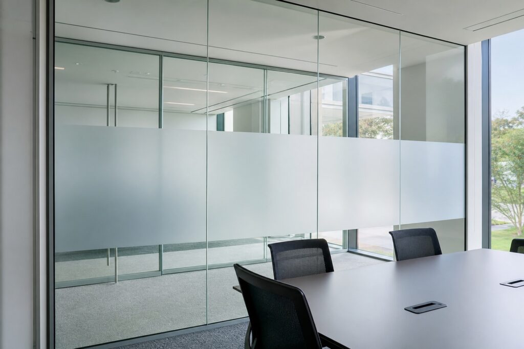 Frosted privacy window film band on the glass walls of an office meeting room